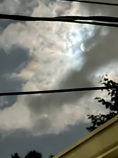 Night photo of moon behind clouds