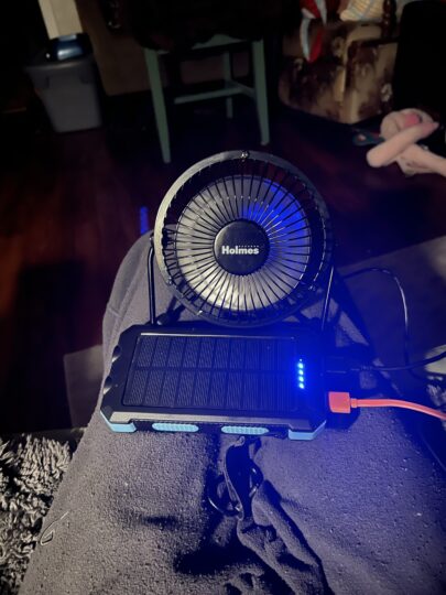 Solar charging battery used for phone shown with usb powered fan. 